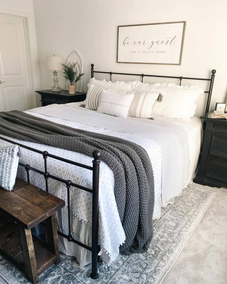 Dark Grey Chunky Knit Blanket on a Black Metal Bed