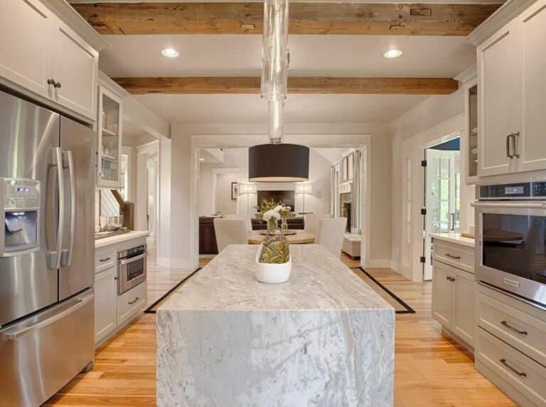 Decorative Warm Wood Beams and a Grey Marble Island