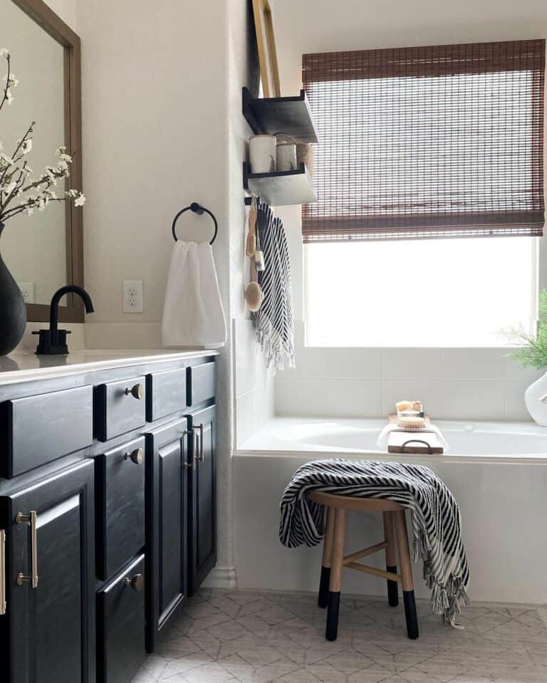 Drop-in Bathtub With Light Wood and Black Stool