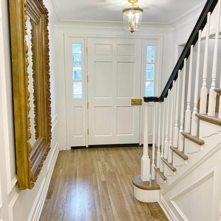 Elegant Entryway With White and Wood Staircase