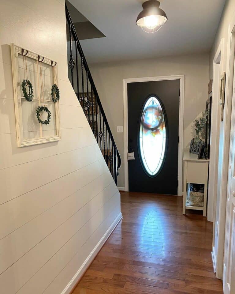 Farmhouse Entryway with Shiplap and Wrought Iron Handrail