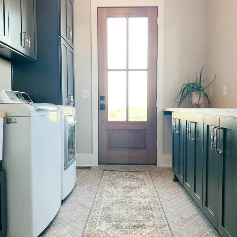 Farmhouse Laundry Room With Dark Green Cabinets