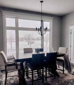 Farmhouse-Style Dining Room With White Window Trim