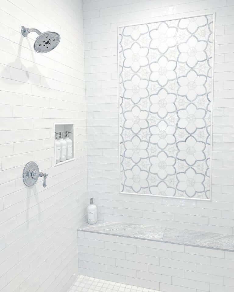 Flowered Accent Tile on a White Tile Wall