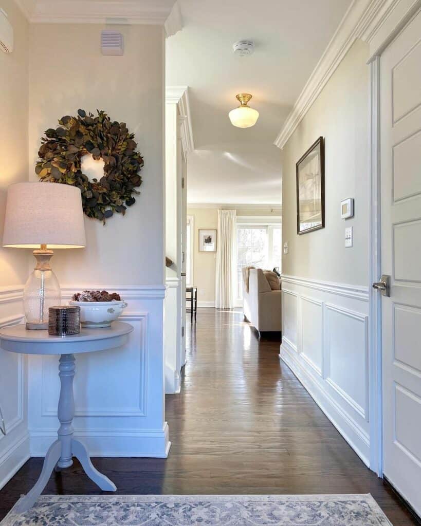 Glass Hallway Chandelier Above a Dark Wood Floor