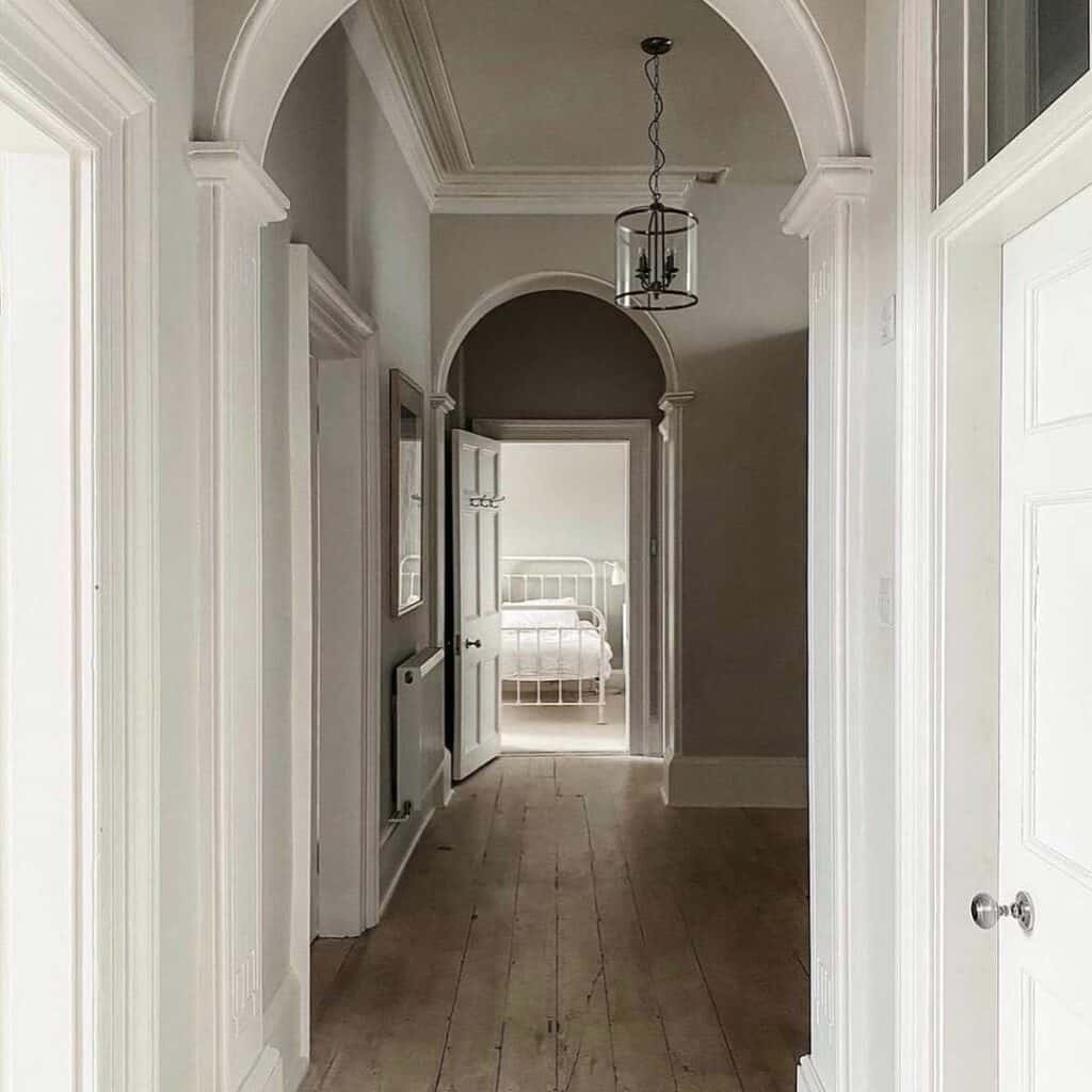 Glass Hallway Chandelier Over a Warm Wood Floor