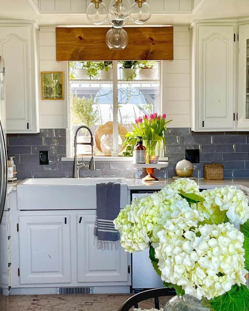 Glossy Gray Tile Backsplash and White Farmhouse Cabinets