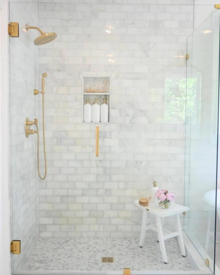 Gray and White Subway Tile Shower with Gold Fixtures