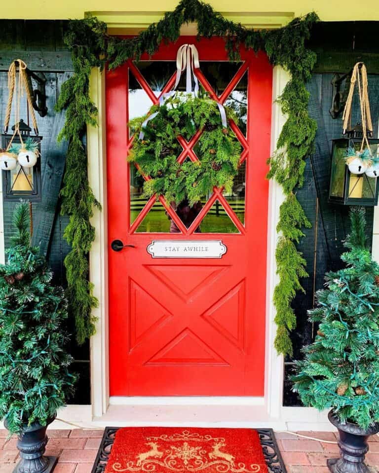Green Wreath and Garland on a Red Front Door