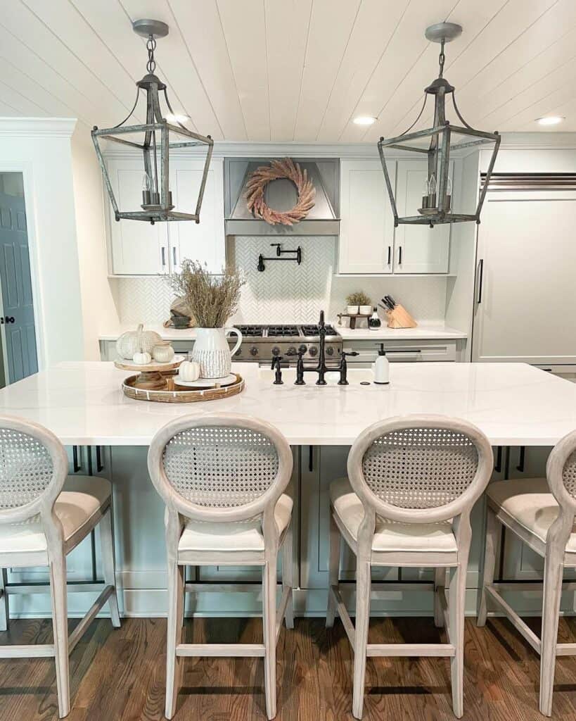 Grey Lantern Pendant Lights and Tall White Chairs