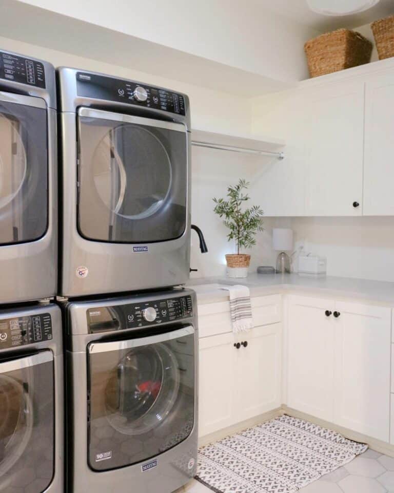 Grey Stacked Washer-and-Dryer Units With White Cabinets