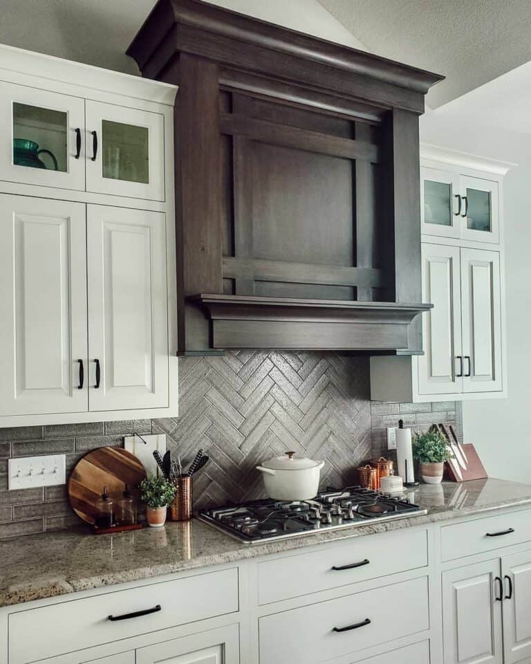 Herringbone Tile Surrounded by White Cabinets