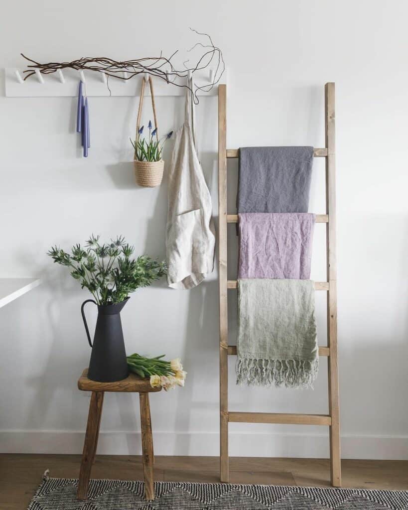Light Wood Ladder With Fringed Blankets