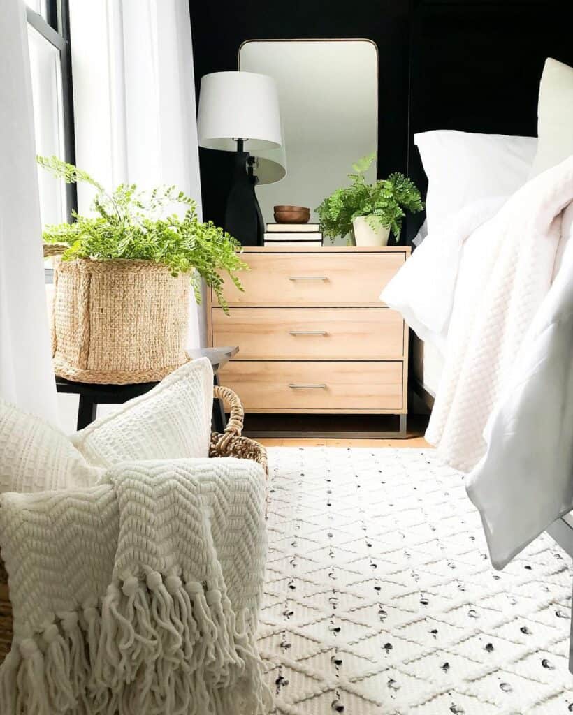 Light Wood Nightstand Against a Black Accent Wall