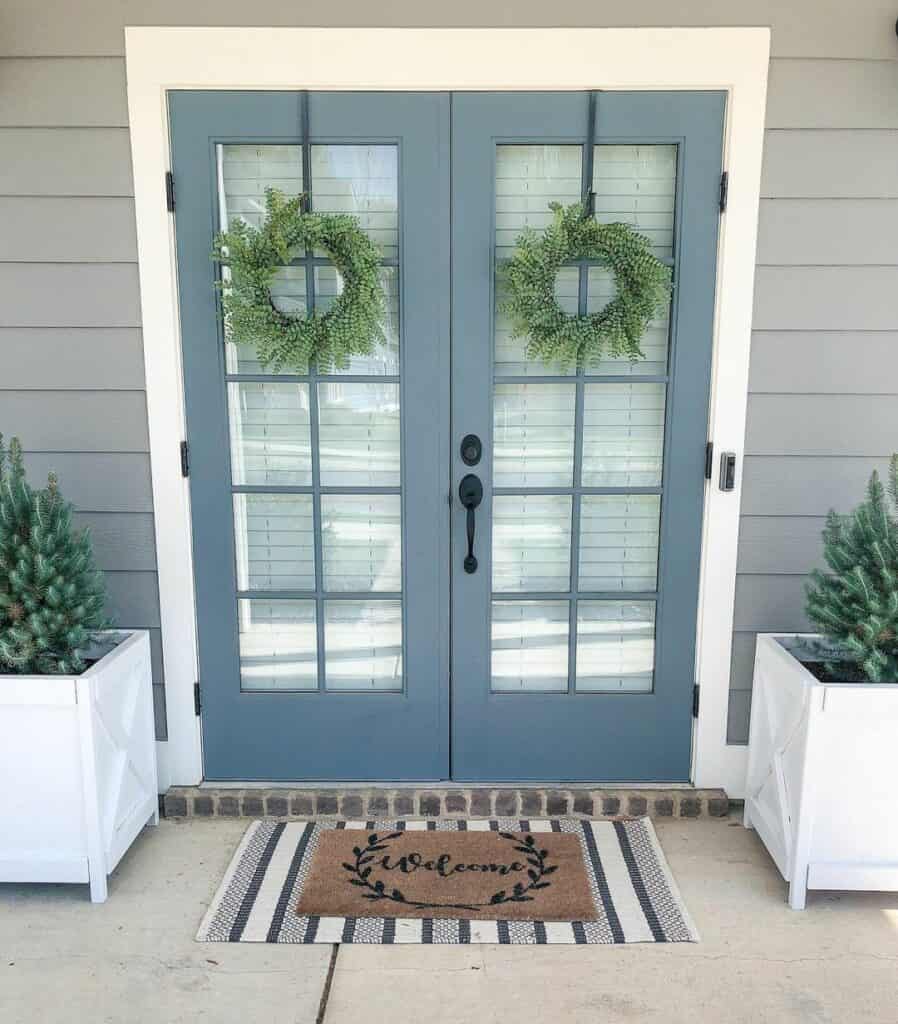 Muted Blue French Doors With Green Wreaths