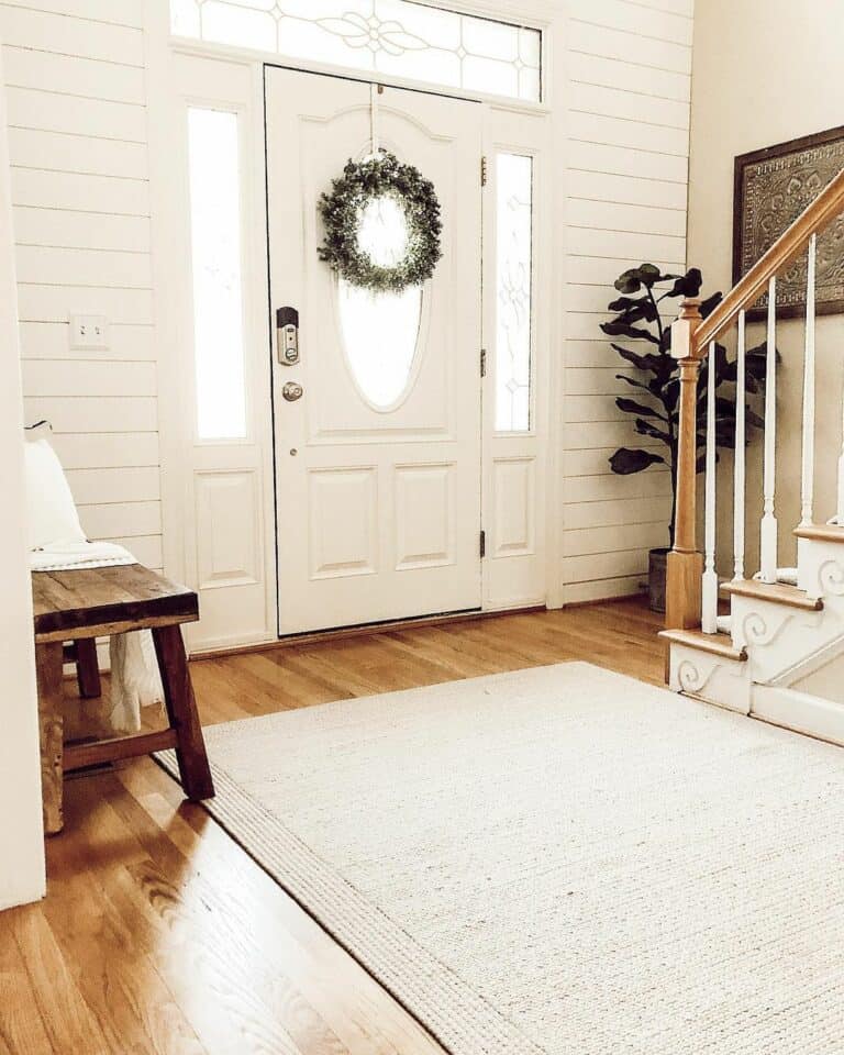 Neutral Entryway with Wood Floor and Shiplap Wall