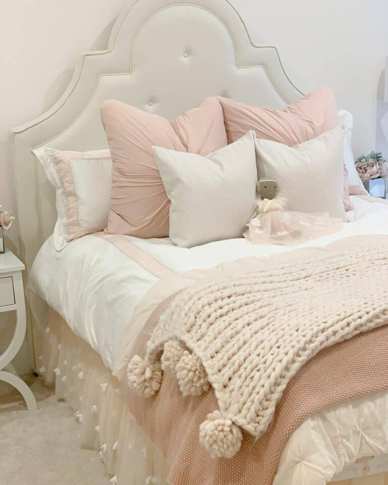 Off-White Chunky Knit Blanket Over a Pink Blanket
