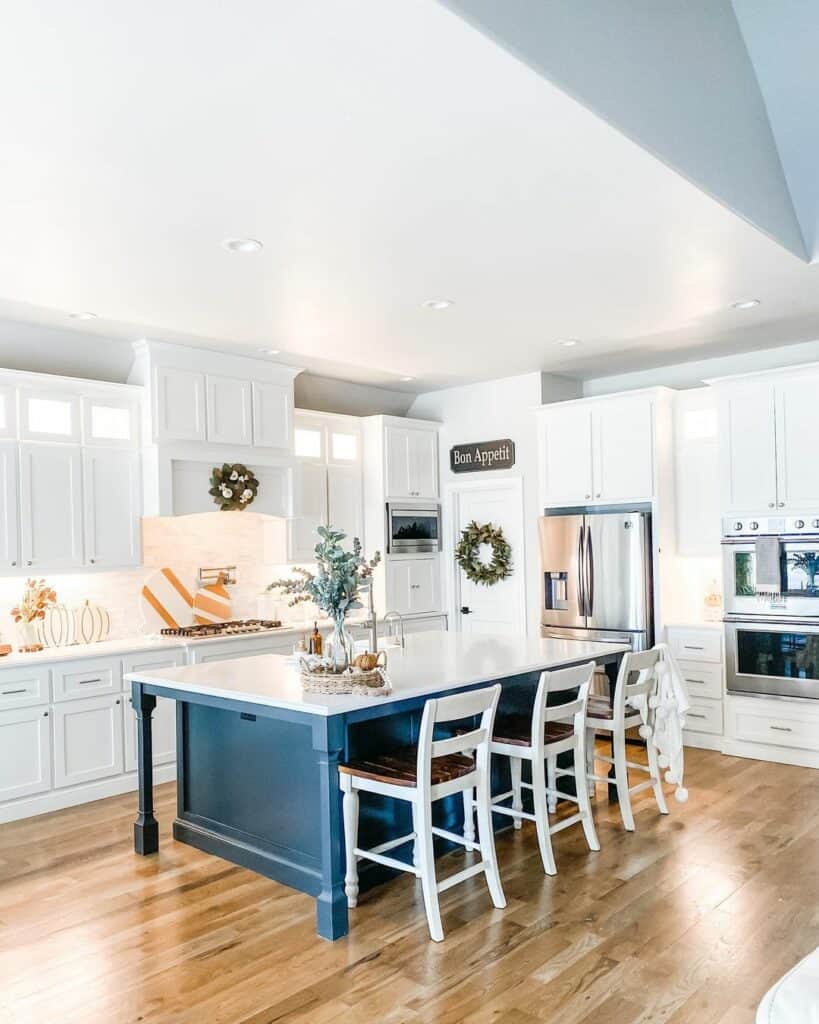 Open-Concept White Kitchen With an Indigo Blue Island