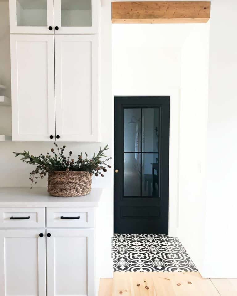 Patterned Tile Leads to Black Kitchen Door
