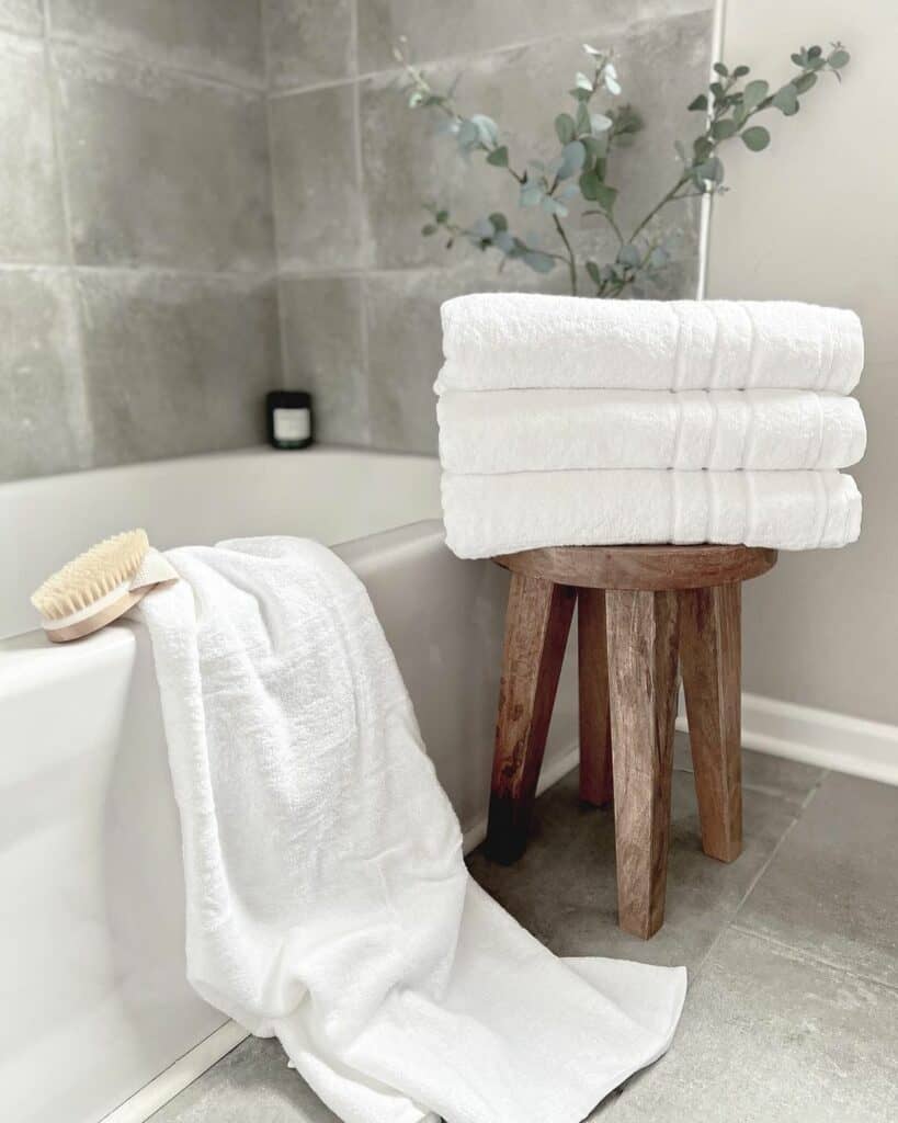 Small Wooden Bathroom Stool With White Towels