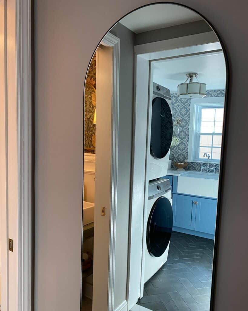 Stacked Laundry Room With Arched Mirror