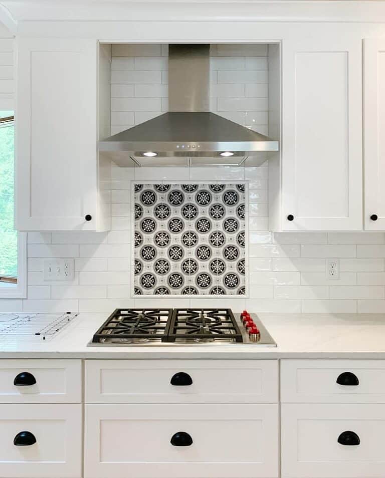 Stainless Range With White and Black Mosaic Tile Backsplash