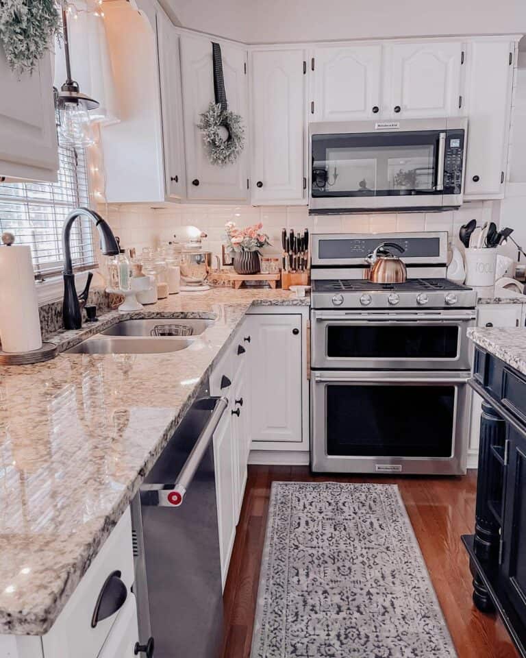 Stainless Steel Stove Against a White Tile Backsplash