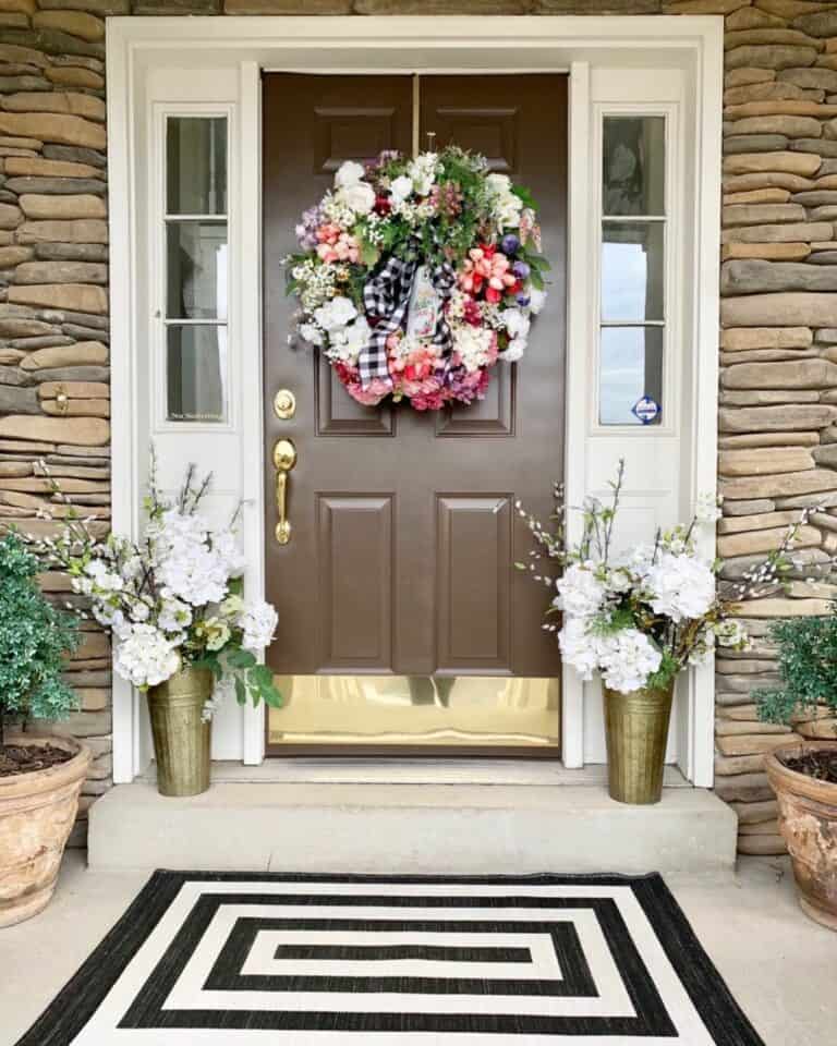 Stone House With Brown Front Door and White Sidelights