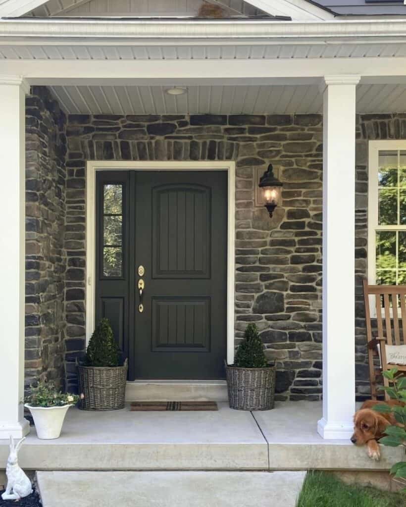 Stone Porch with Black Door and Rocking Chairs