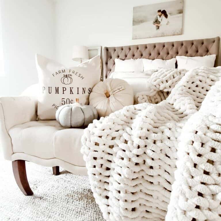 Stuffed White Pumpkins and a White Knit Blanket