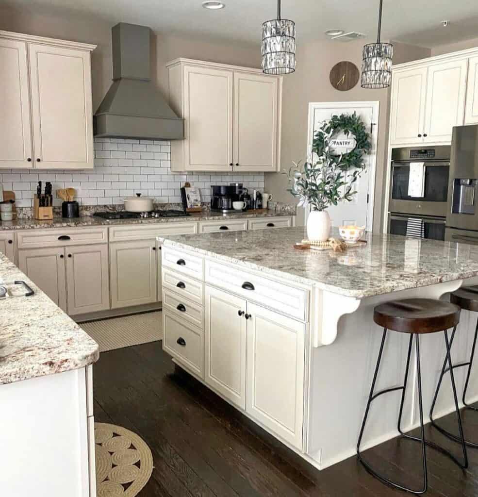 Taupe Kitchen With White Cabinets and Backsplash