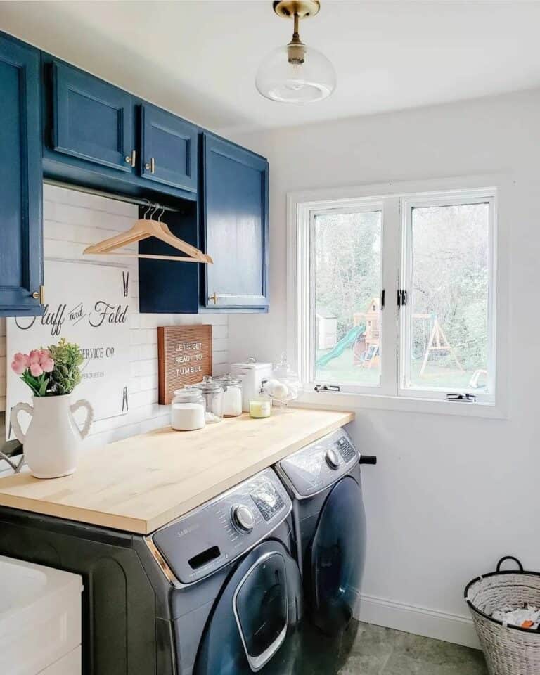 Warm Laundry Room With Navy Blue Cabinets