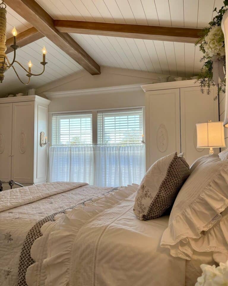 Warm Wood Beams and Ornate White Cabinets