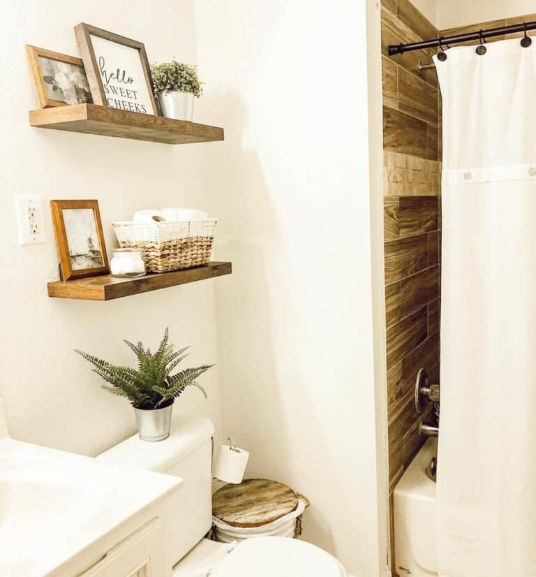 White Bathroom with Floating Shelves Over Toilet