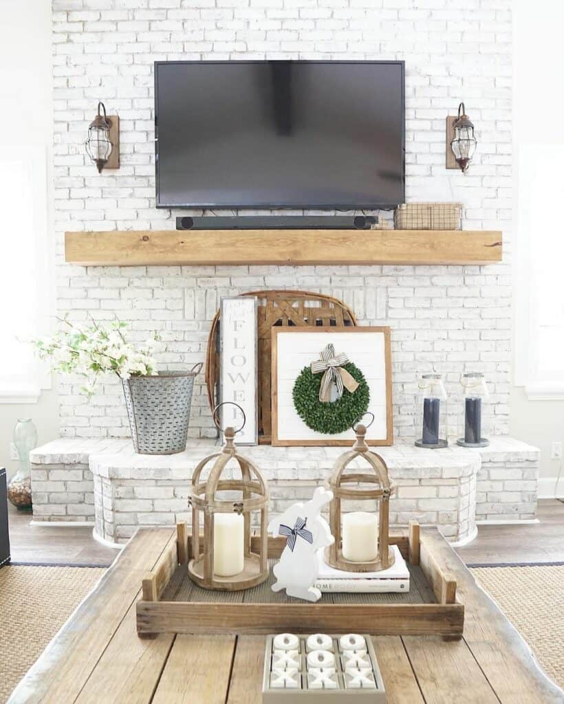 White Brick Fireplace With TV on Mantel
