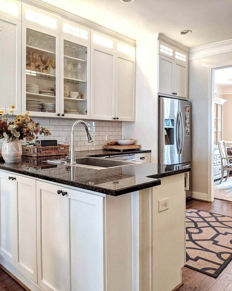 White Cabinets With Interior Lighting and Black Hardware