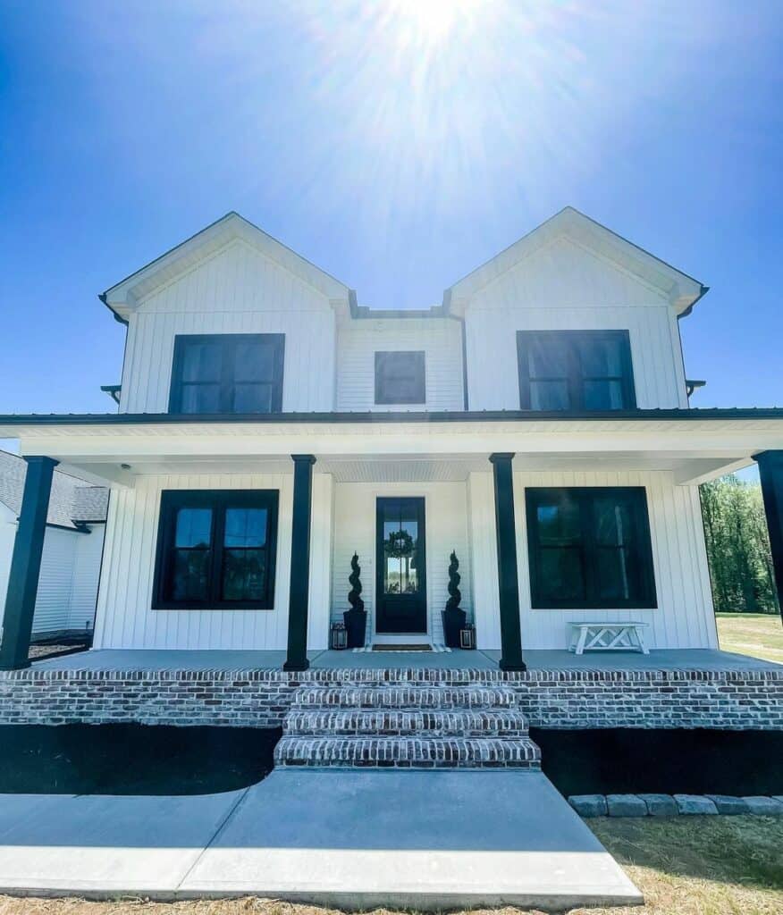 White Covered Front Porch with Black Posts