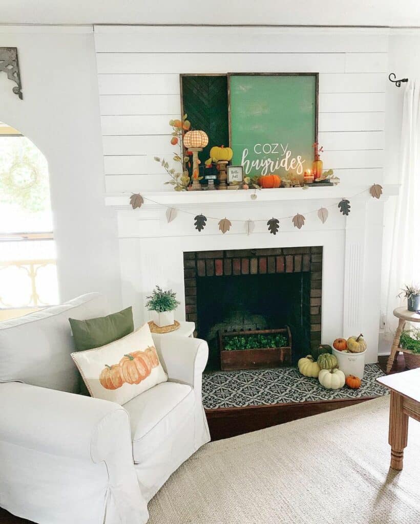 White Fireplace Mantel with Green Autumn Décor
