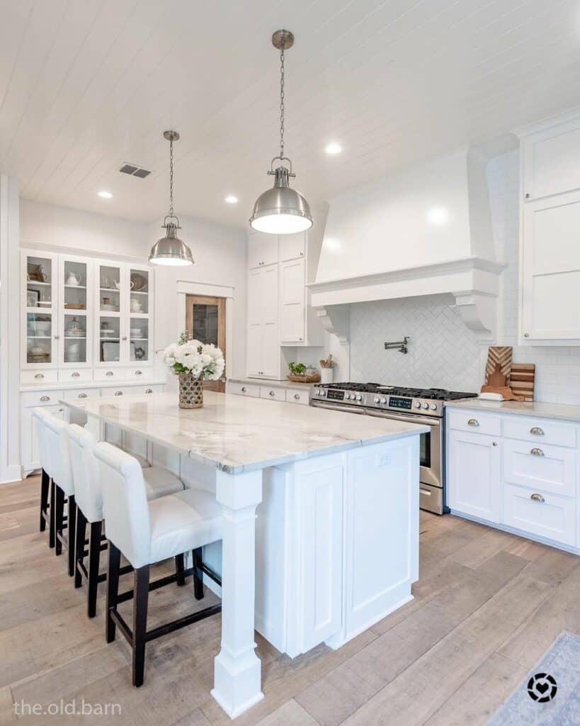 White Kitchen With Metal Pendant Lighting