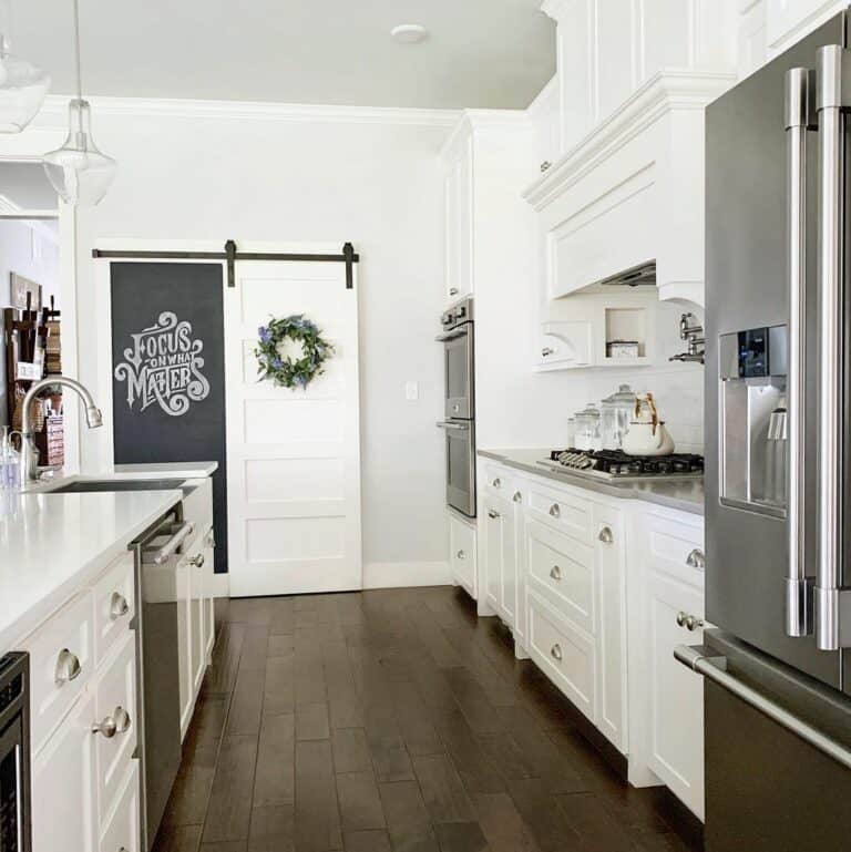 White Pantry Barn Door with Green Wreath