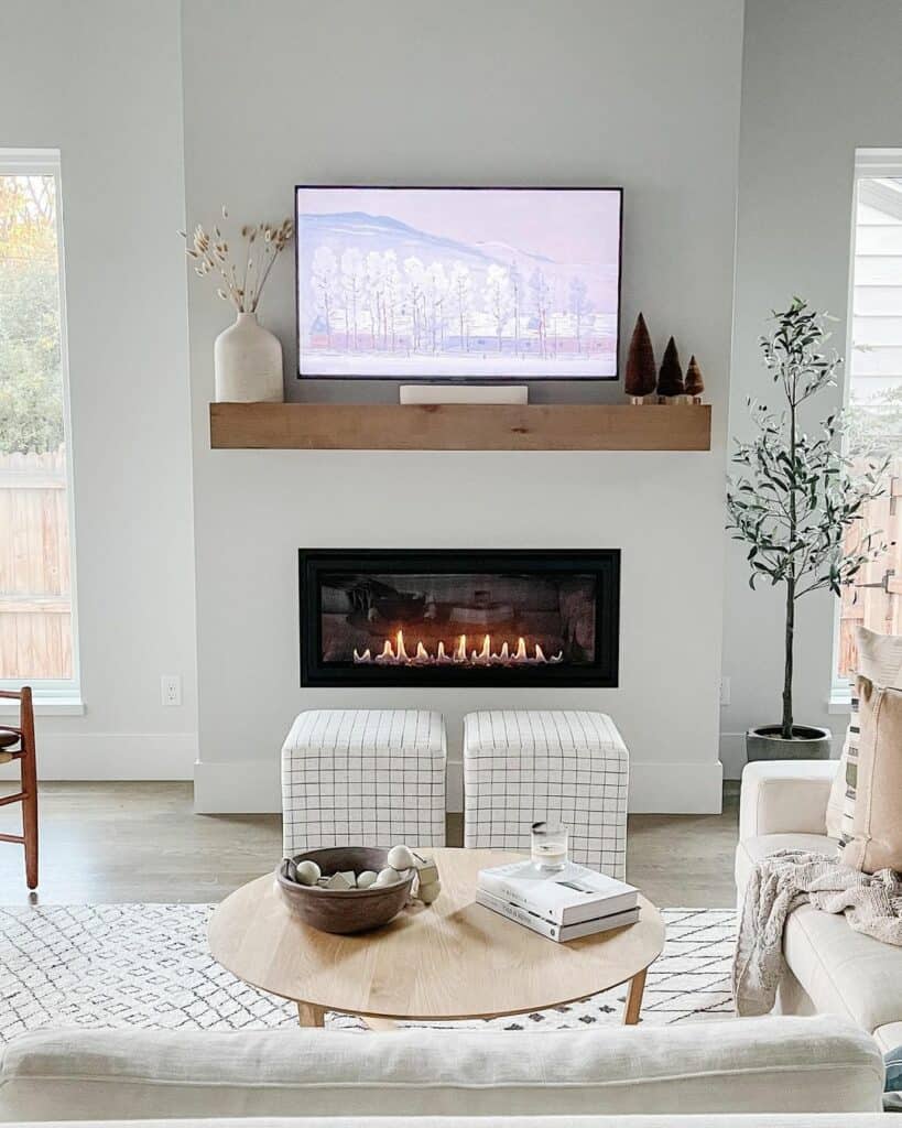 White Poufs in Front of a Linear Fireplace