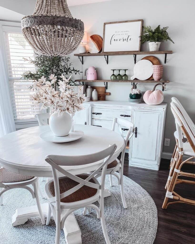 White Round Dining Table With Centerpiece and Chandelier