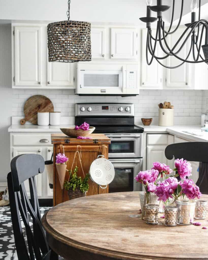 White Tile Backsplash and Cabinetry With Pink Accents