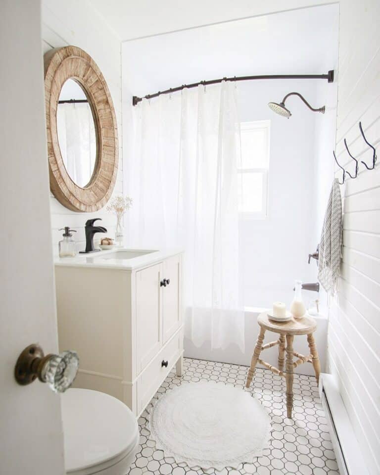 White Tub and Shower Combo With Light Wood Stool