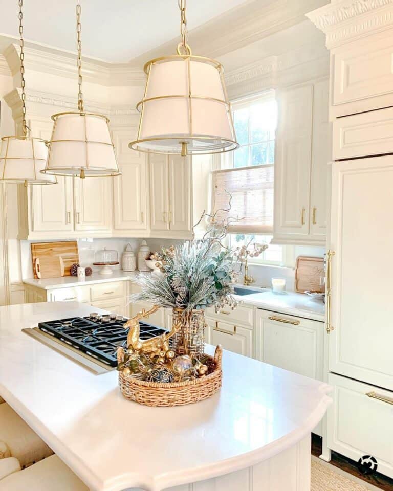 White and Gold Lamps Over a White Kitchen Island