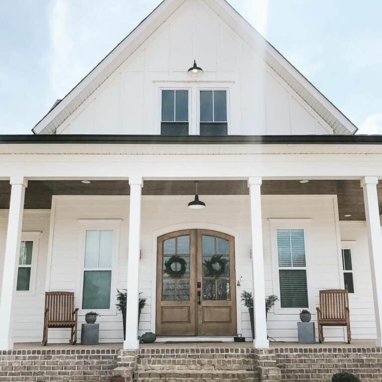 Wood Double Front Doors With Green Wreaths