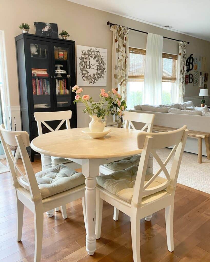 Wood and White Round Dining Table With Centerpiece