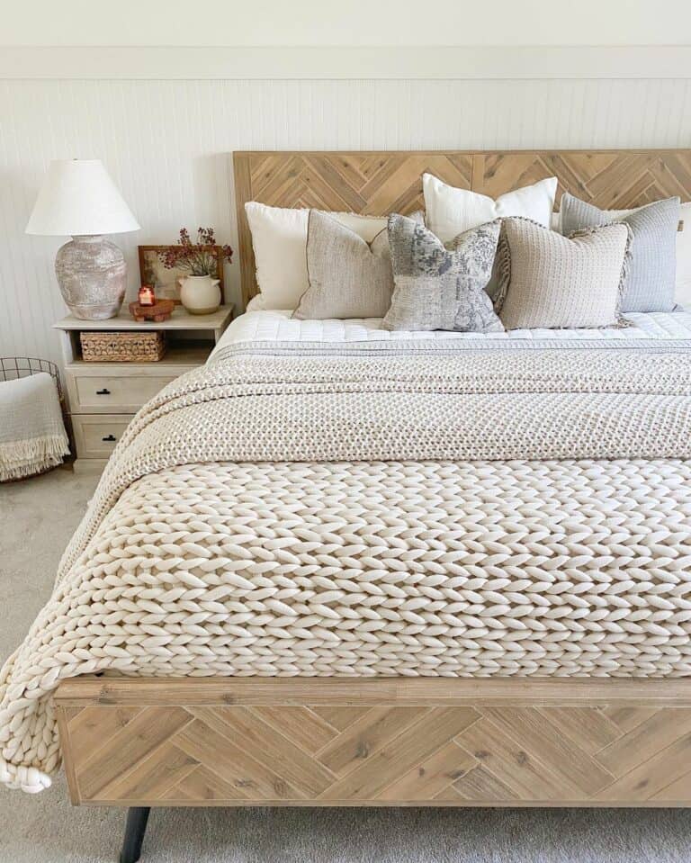 Wooden Bed With Knitted Blankets in a Neutral Bedroom