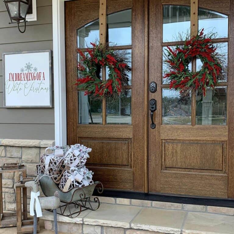Wooden Double Doors With Red Berry Wreaths