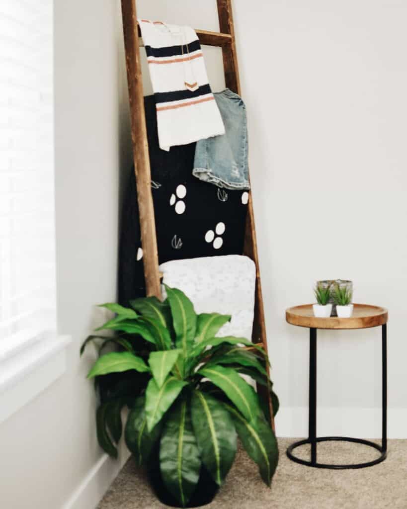 Wooden Ladder With White and Black Blankets